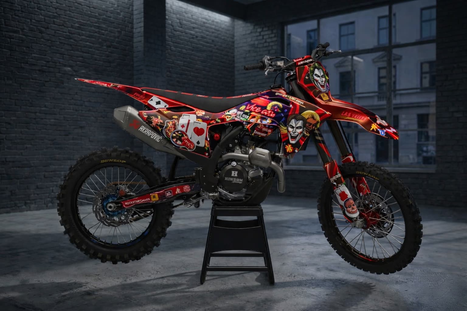 Red custom motocross graphics with Joker casino artwork and playing card elements.