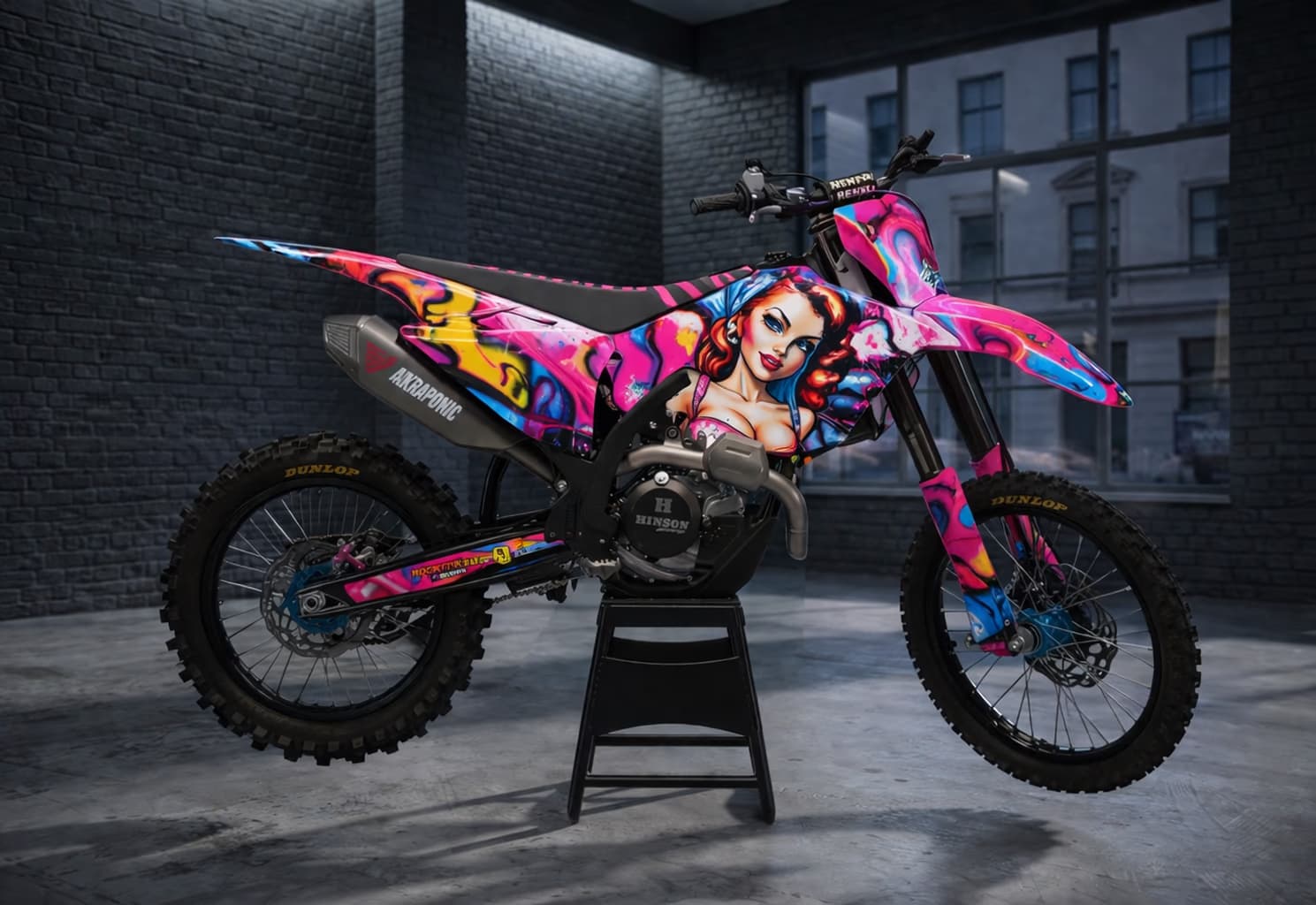 Pink custom dirt bike graphics featuring neon pinup style artwork.